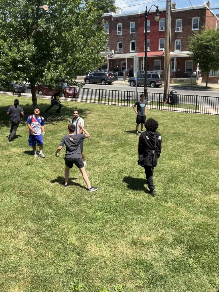 Students are on the front lawn with water balloons