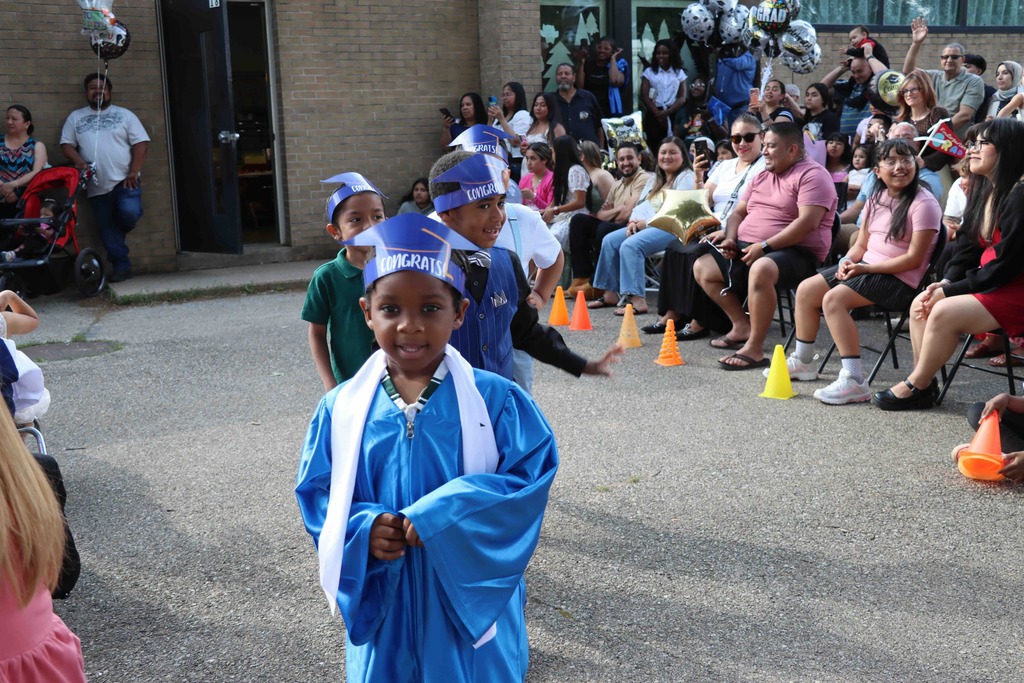 Students walk to their seats at the Kindergarten graduation ceremony.
