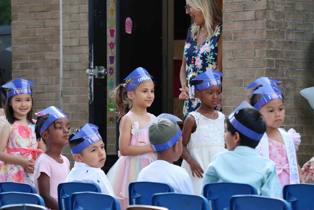 Students walk to their seats at the Kindergarten graduation ceremony.