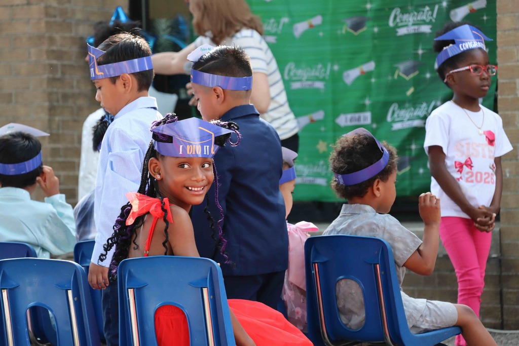 A student smiles at family members.