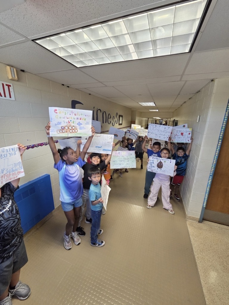 Fourth graders march through the school for their celebratory parade.