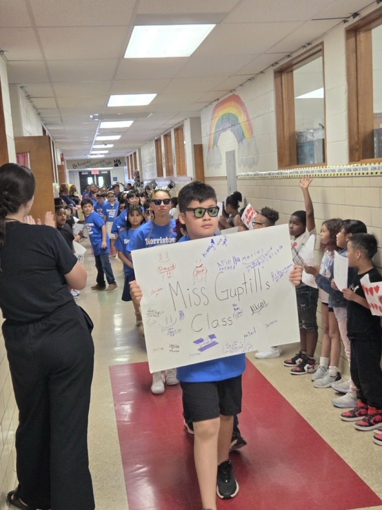 Fourth graders march through the school for their celebratory parade.
