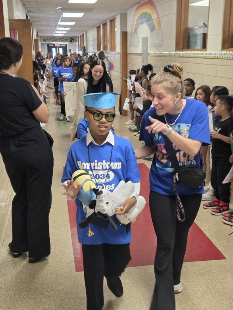 Fourth graders march through the school for their celebratory parade.