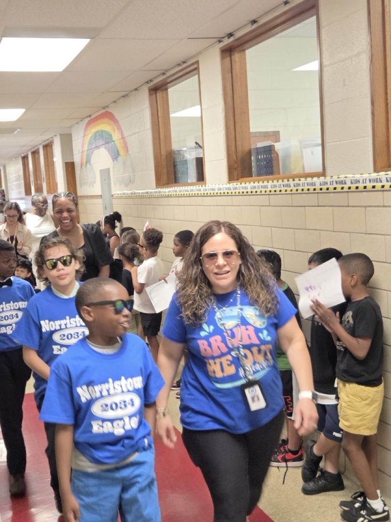 Fourth graders march through the school for their celebratory parade.