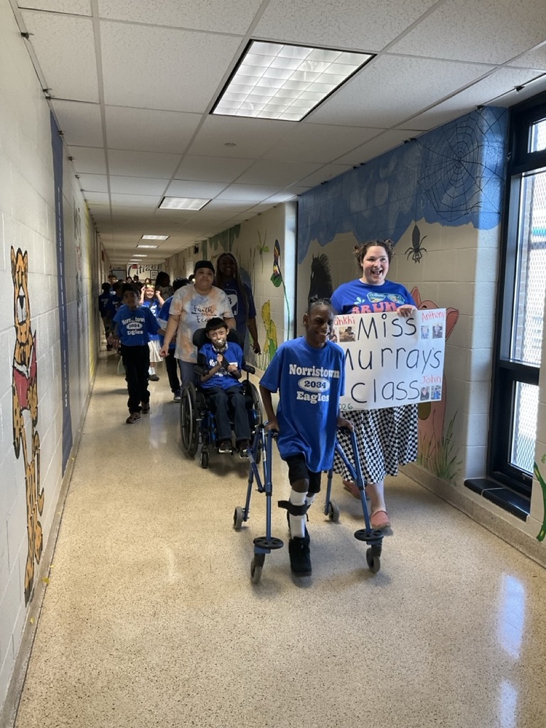 Fourth graders march through the school for their celebratory parade.