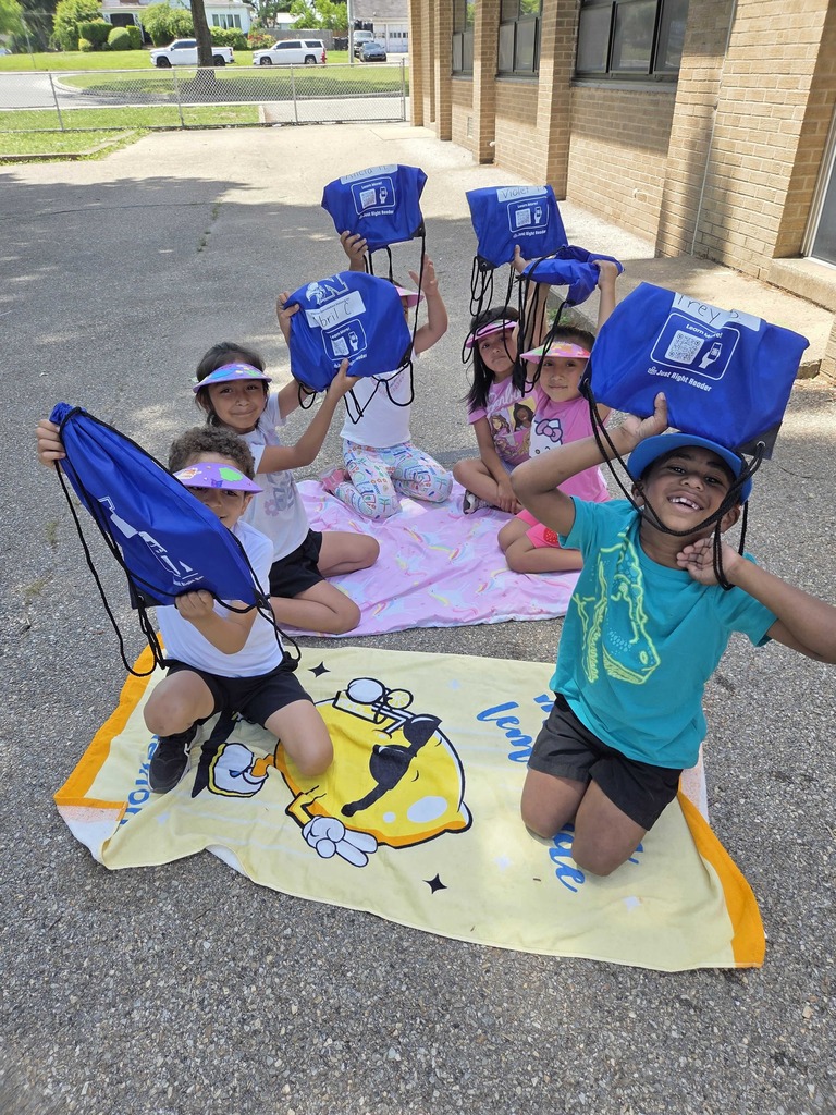 Students proudly show their new bag of books.