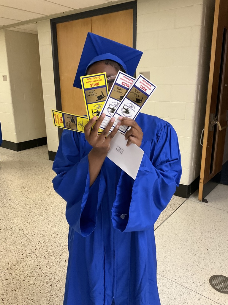 A student is holding her tickets for commencement