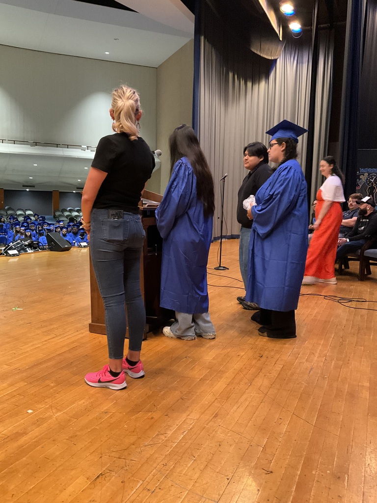 Students and staff are on stage practicing