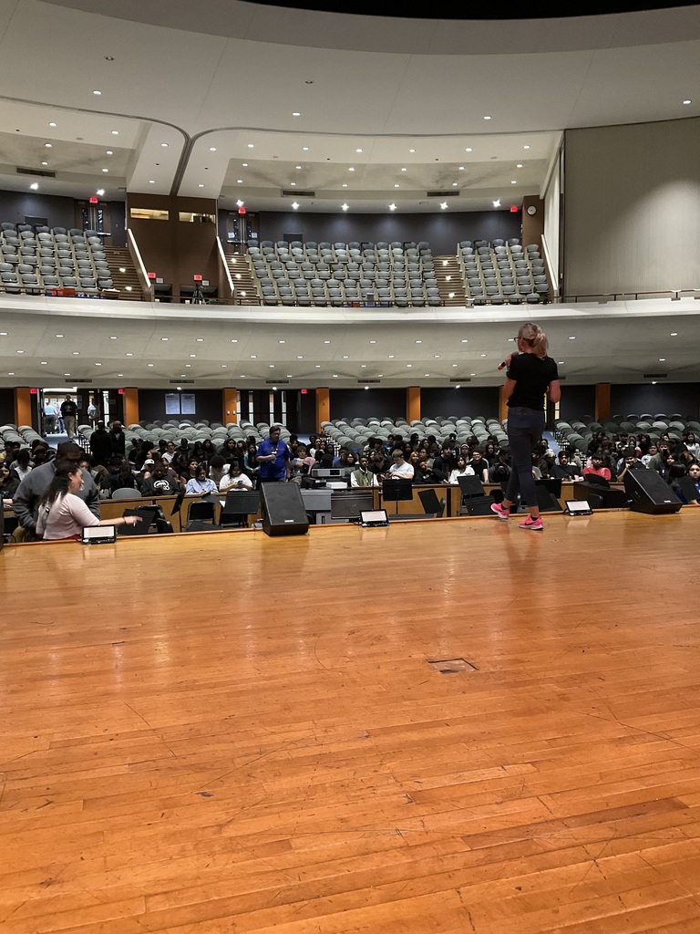 Students and staff are in the auditorium