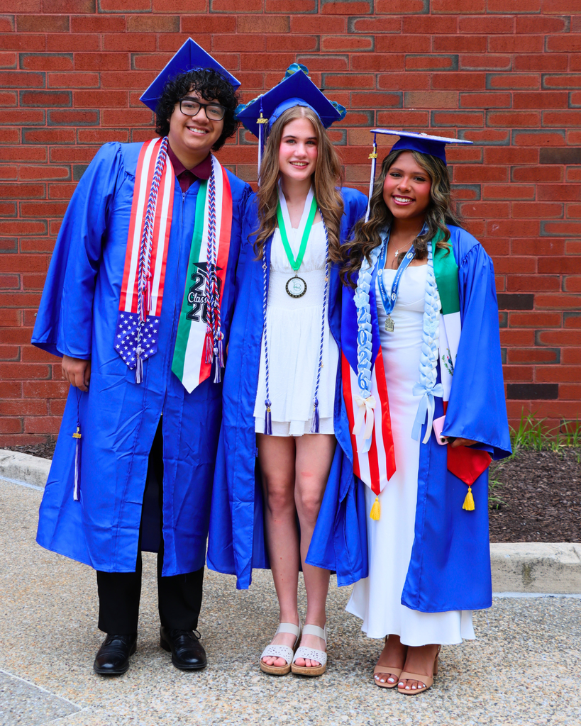 Three graduates pose for photo.