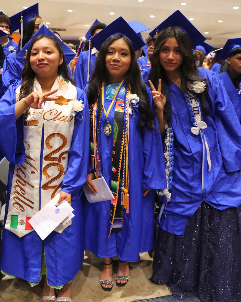 Three graduates pose for photo.