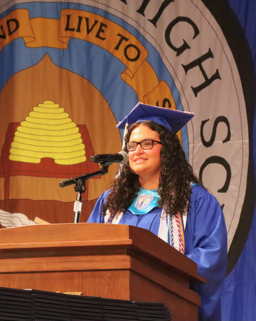 Graduate giving speech at podium.