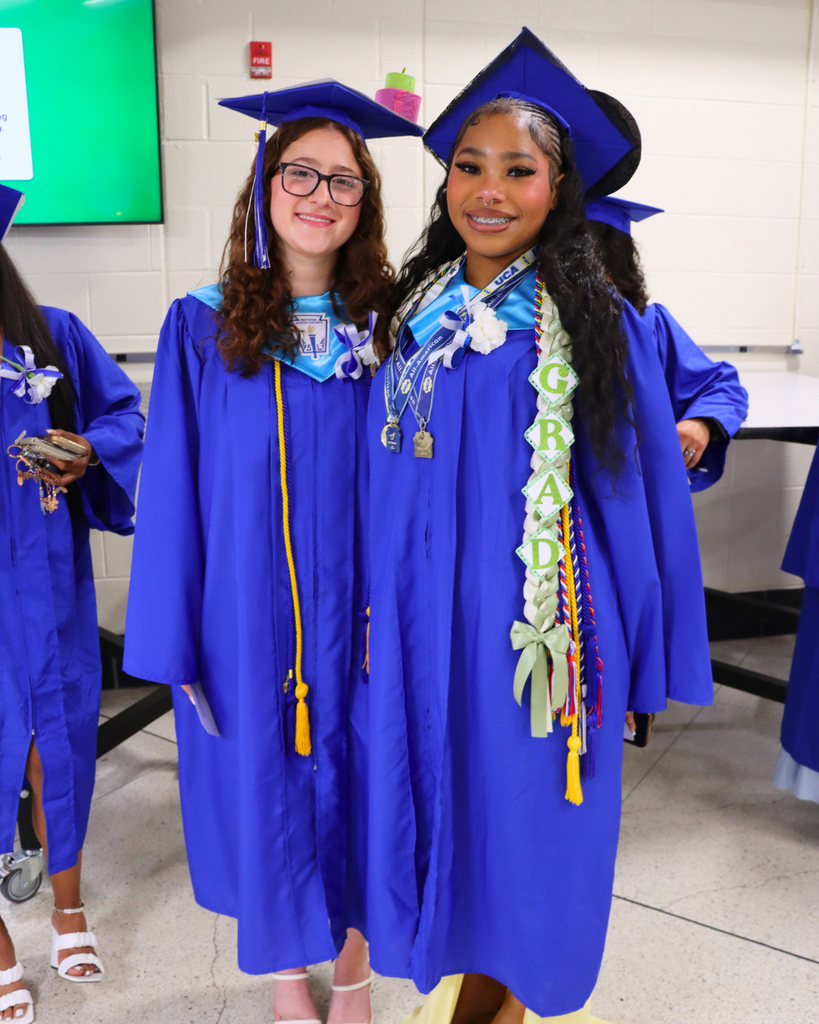Two graduates pose for photo.