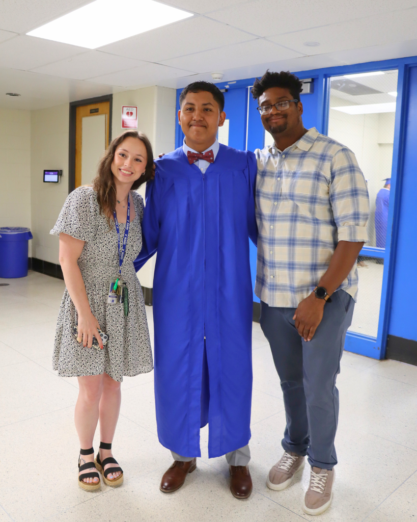 Graduate and teachers pose for a photo.