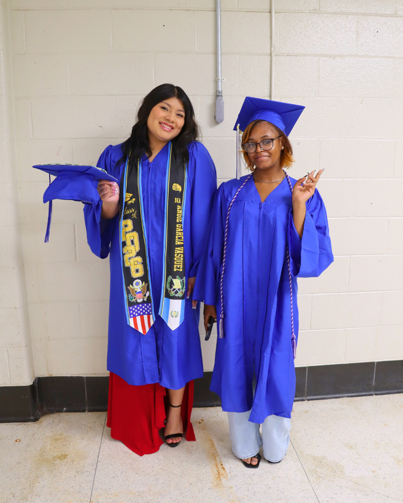Two graduates pose for photo.