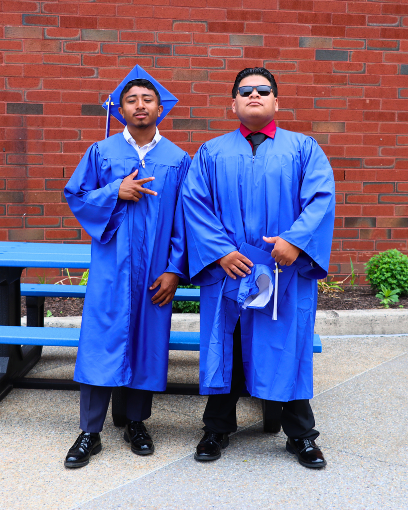 Two graduates pose for photo.