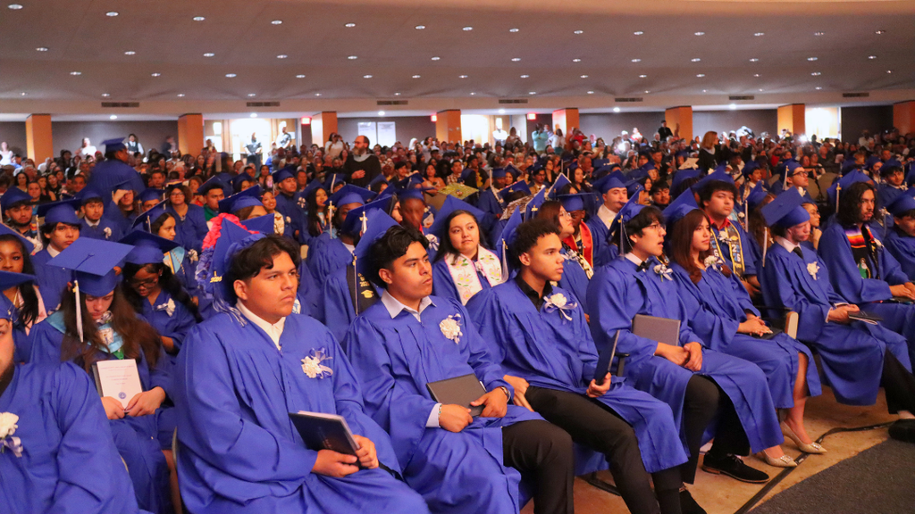 Auditorium full with graduates and families.