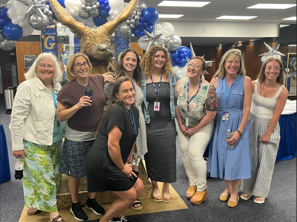Teachers are gathered in a group at graduation 