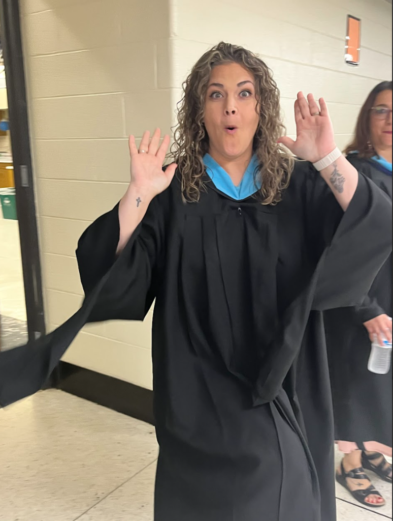 A teacher is posing for the camera
