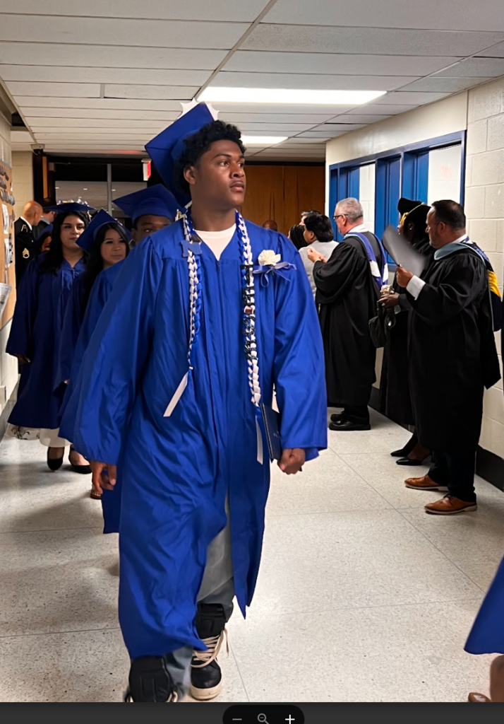 Students are walking out of the auditorium after commencement 
