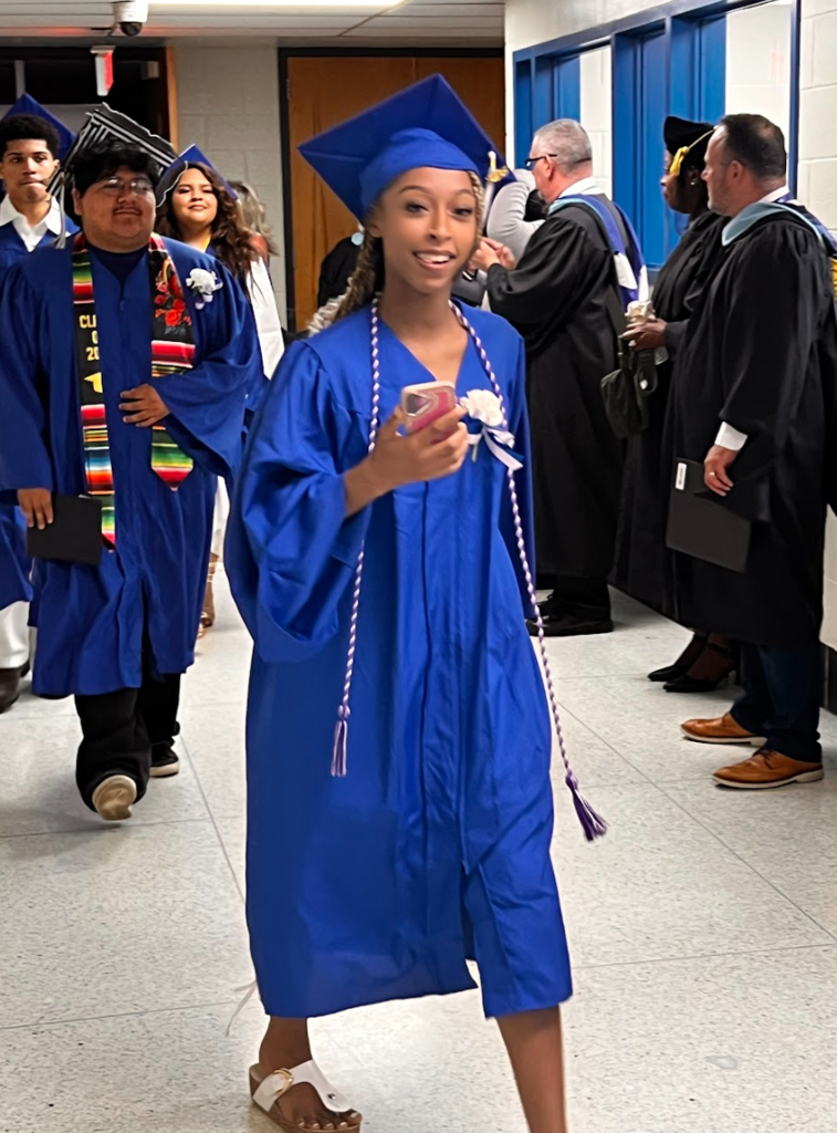 Students are walking out of the auditorium after commencement 