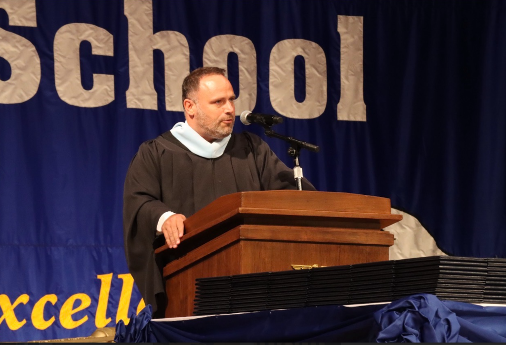 The principal is giving a speech 