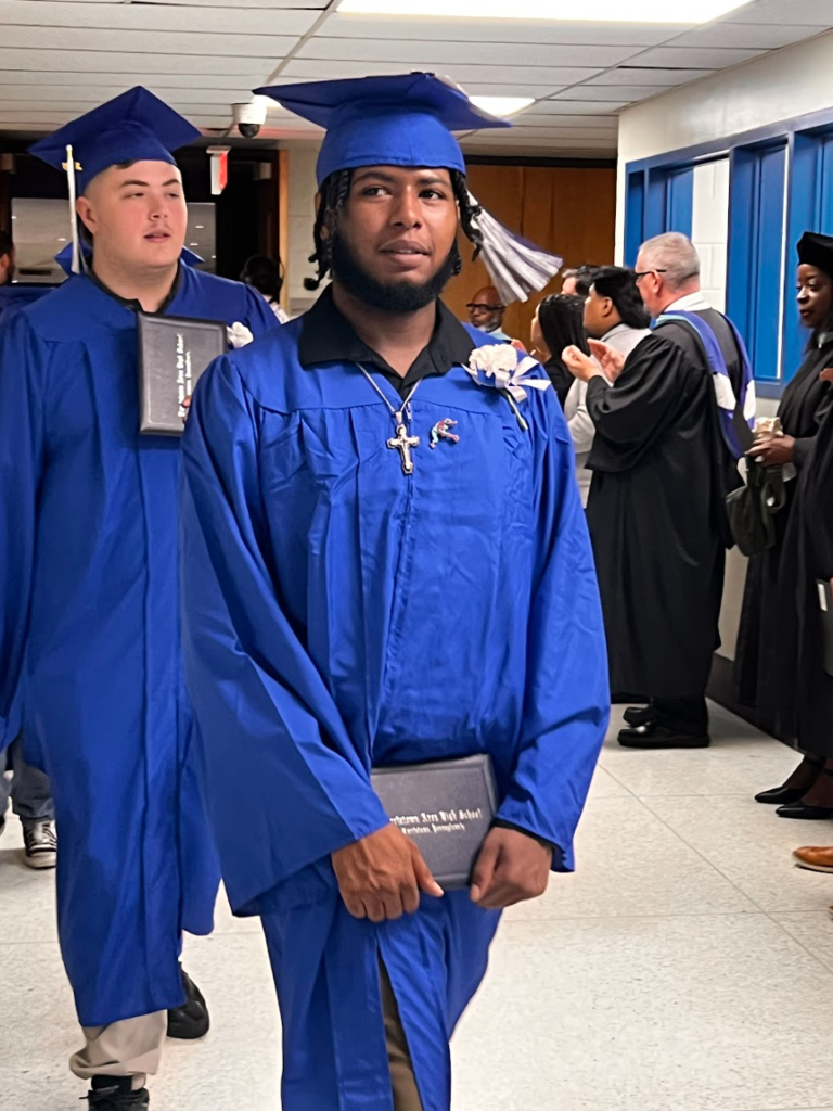 Students are walking out of the auditorium after commencement 