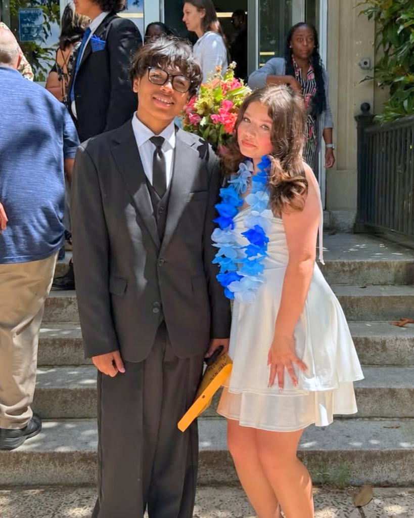 Two students pose for photo after 8th grade graduation.