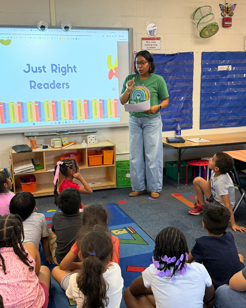 Reading specialist introducing herself to students before they open their packs of books.