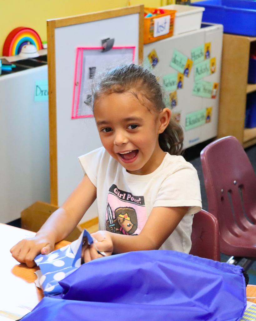 Student is surprised when she opens her pack of books.