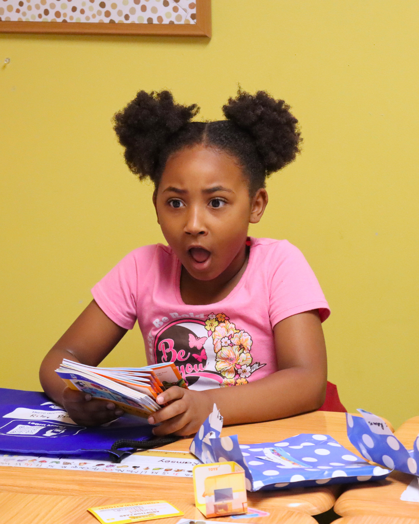 Student is surprised when she opens her pack of books.