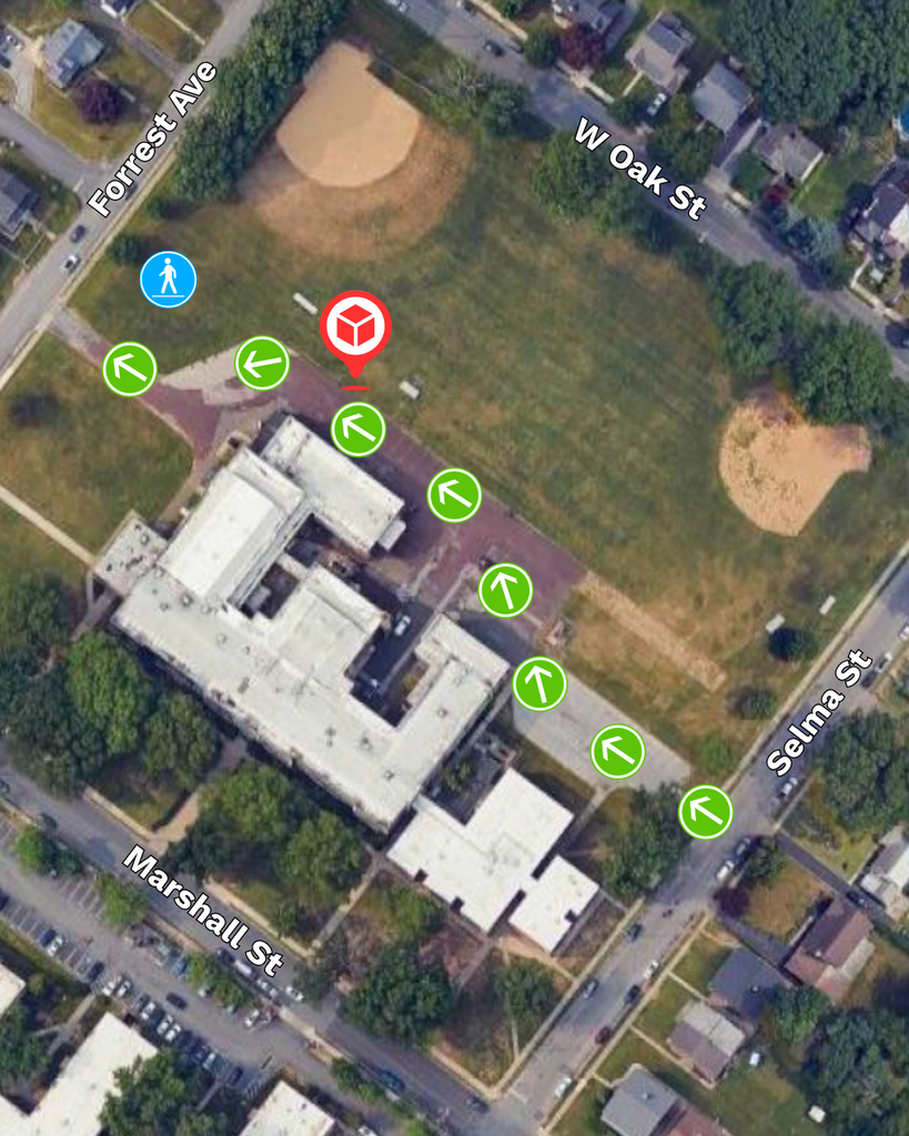 Aerial map showing Blockson Middle School with arrows indicating the drive-up and walk-up routes for meal kit distribution. The route enters from Selma Street and exits onto Forrest Avenue. Full details in caption.