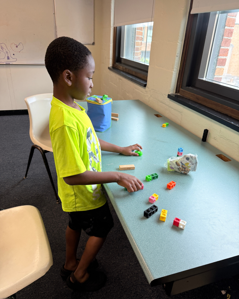 Student playing with number blocks.