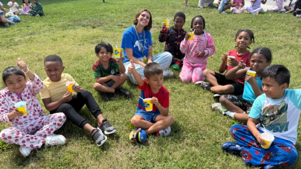 Students and teacher enjoying water ice outside.