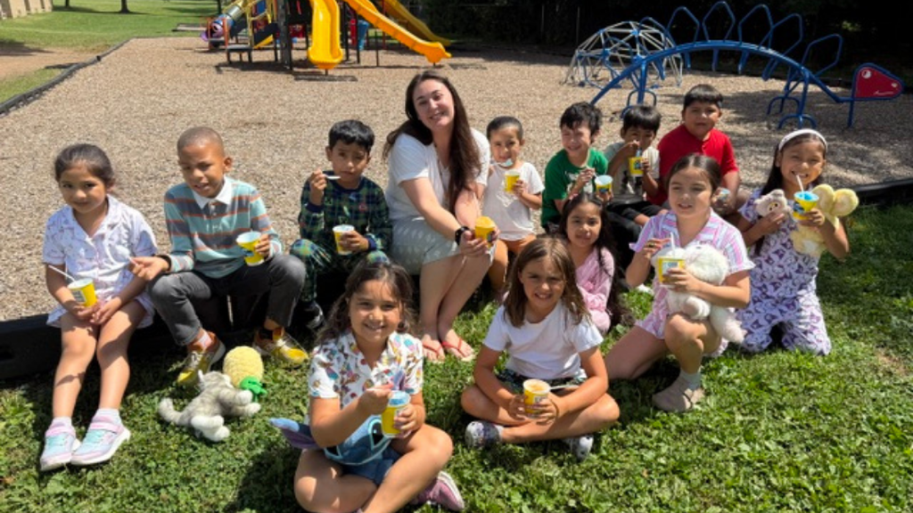 Students and teacher enjoying water ice outside.