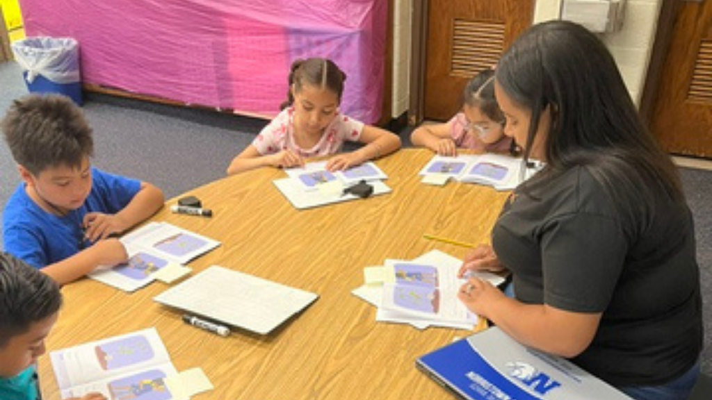 Students practicing reading in a small group.