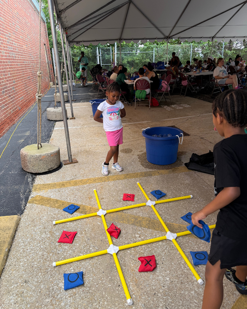 Young students playing yard tic-tac-toe.