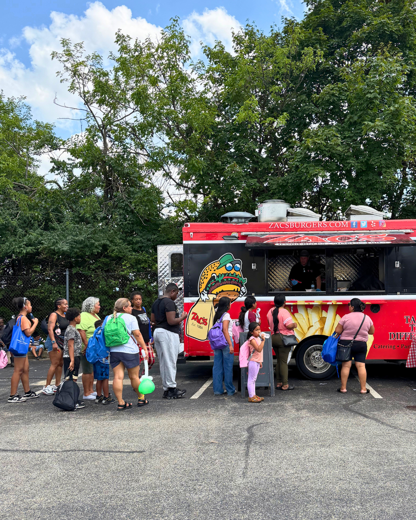Zac's burger truck with line of people waiting.