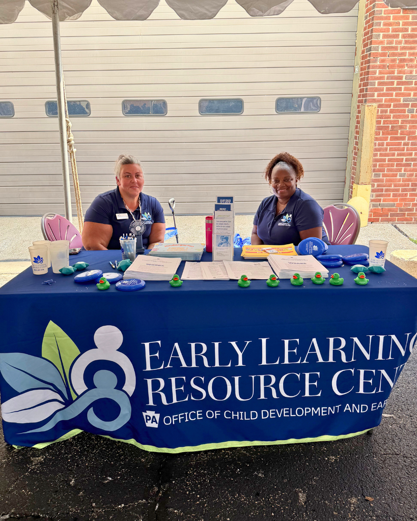 ELRC staff sitting behind their table with information and resources.