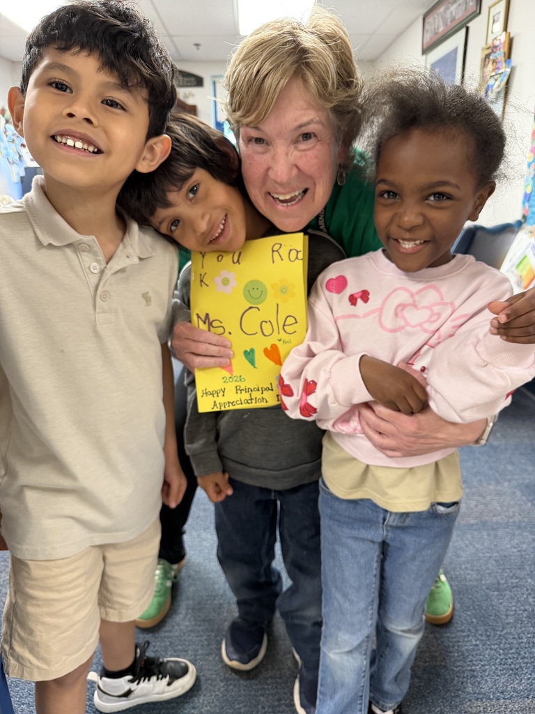 Dr. Cole with three students that gave her a card for Principal Appreciation Day.