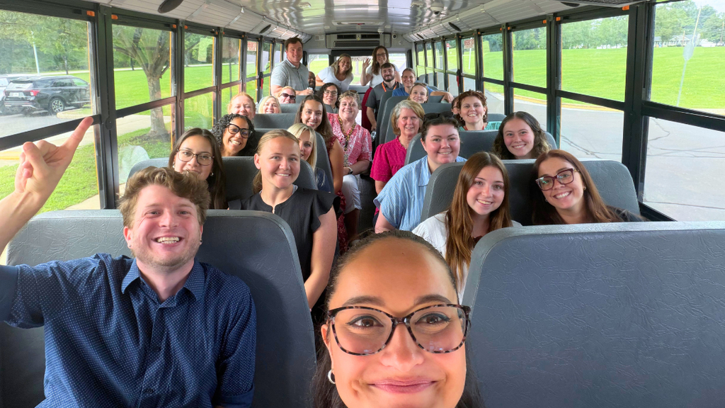 Second group of new teacher and bus tour guides take selfie on bus