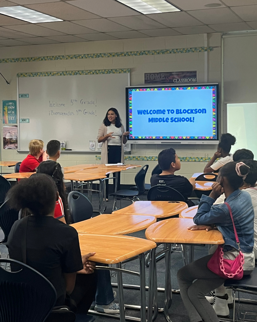 Students sitting in desk with teacher pointing at board that says "Welcome to Blockson Middle School"