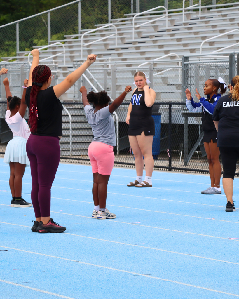 High school cheerleaders teaching the younger studnets.