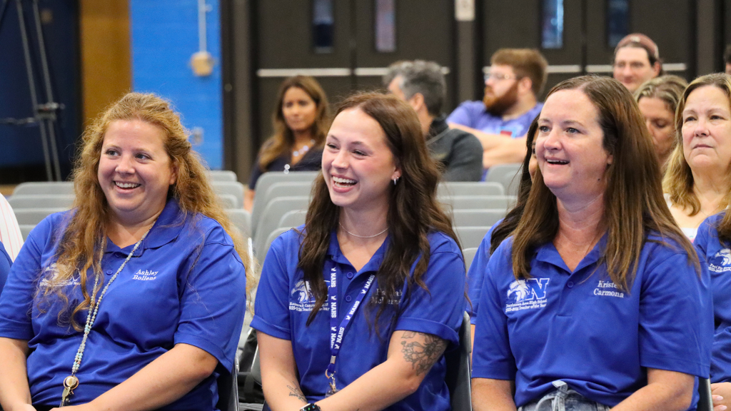 Teachers smiling during presentation.
