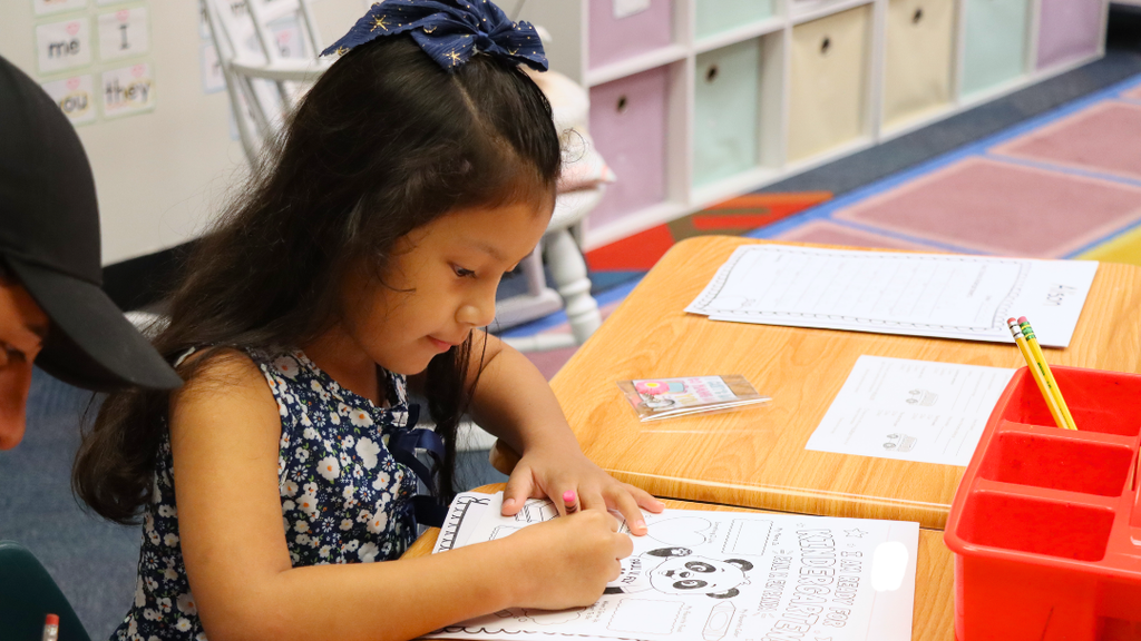 New kindergarten student coloring during orientation.
