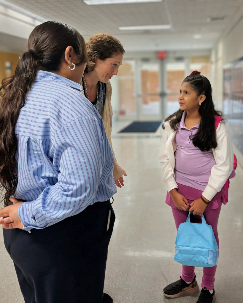 Staff welcoming a student.
