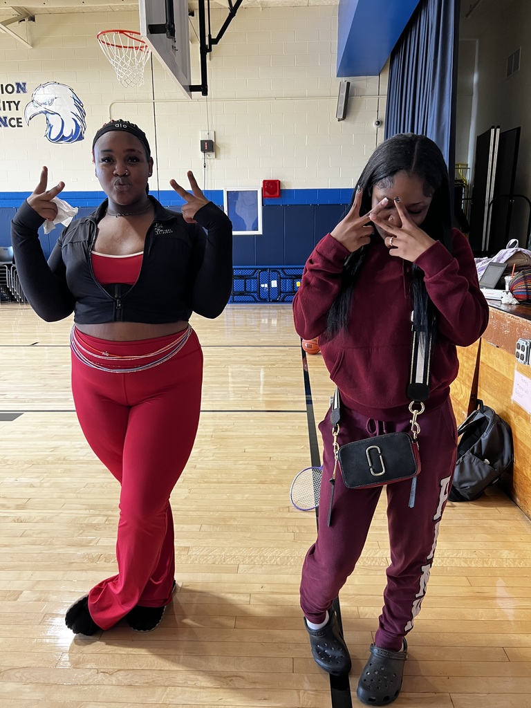 Two girls are posing in the gym