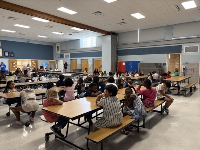 Mrs. Rooney reviews cafeteria expectations on the first day of school.
