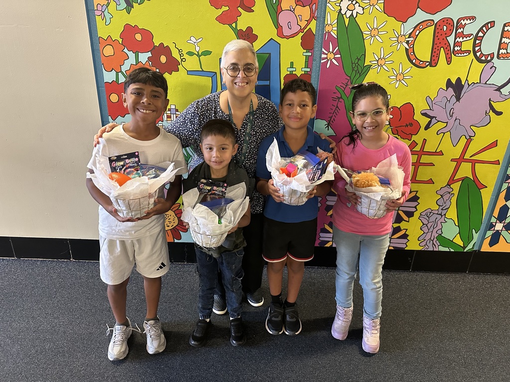Picture of Ms. Fernandez, the principal, and four students who won prizes.