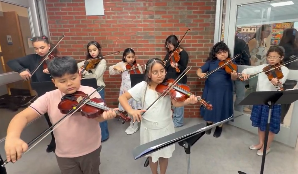 instrumental music students playing for the Board of Directors